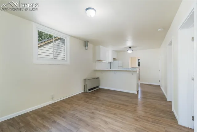 a view of kitchen cabinets and wooden floor
