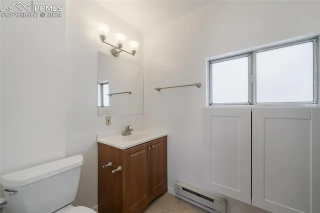 a white toilet sitting next to a bathroom sink
