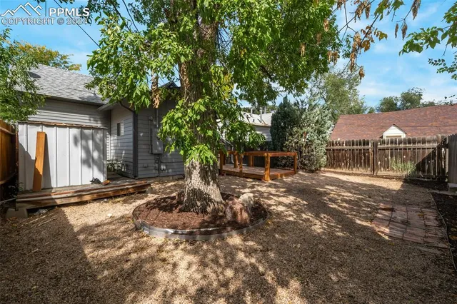 a view of a house with a yard covered in snow