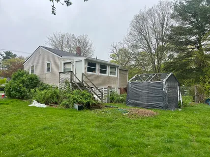 a view of a house with a yard and plants