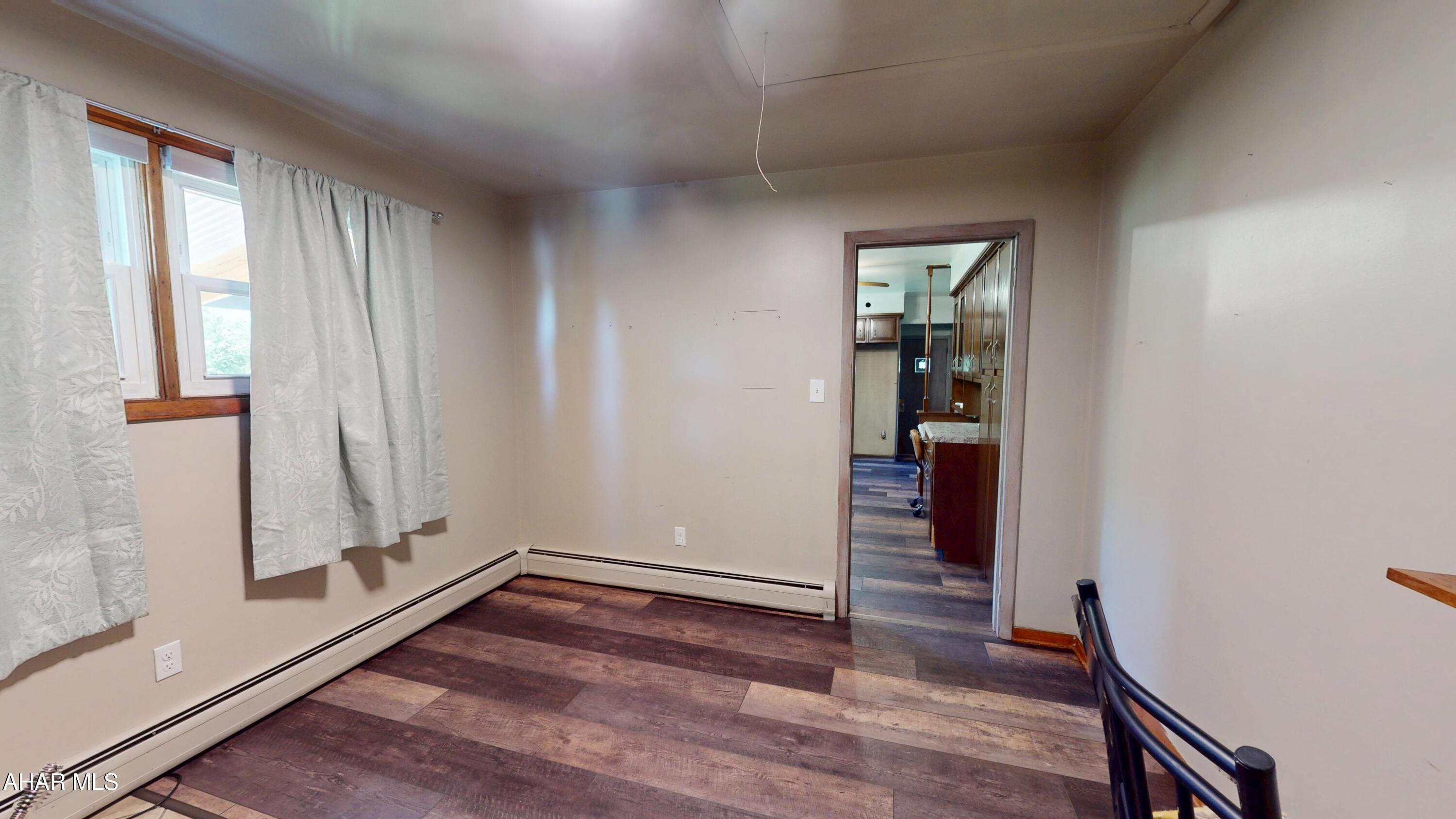 871 Decker Hollow Road Tyrone, PA 16686 - Photo 18 of 35 an empty room with wooden floor and entrance
