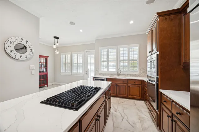 a living room with stainless steel appliances wooden floor and a fireplace