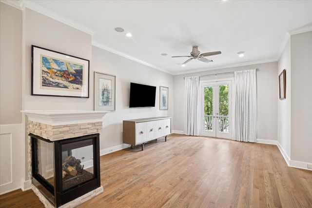 a view of a livingroom with a ceiling fan window and wooden floor