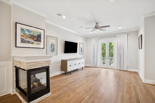 a view of a livingroom with a ceiling fan window and wooden floor