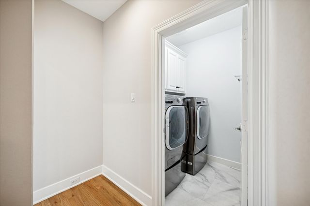 a view of a yard with plants and trees