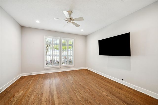 a view of hallway with stairs and wooden floor