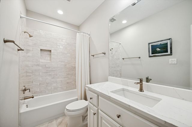 a kitchen that has a cabinets a sink and a refrigerator
