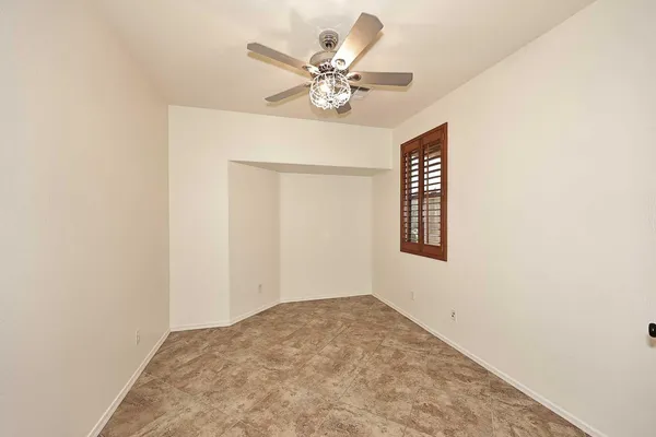 a view of a hallway with a ceiling fan