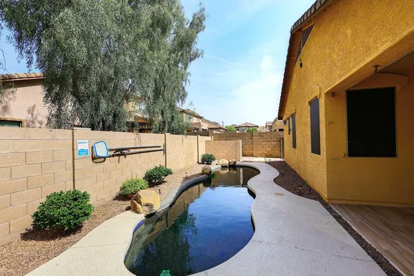 a swimming pool with outdoor seating and plants
