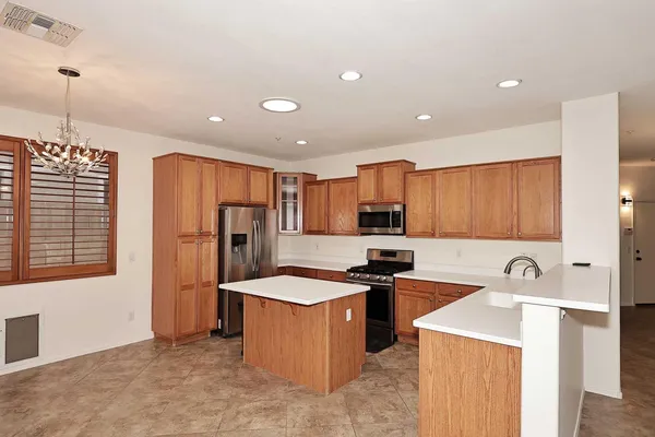 a kitchen that has a sink a refrigerator and a stove