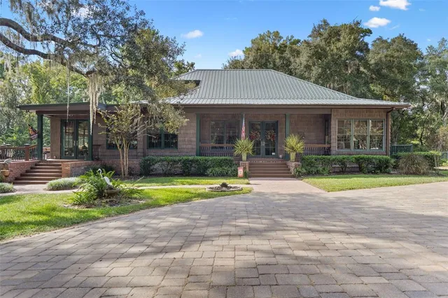 a view of a house with backyard and tree s