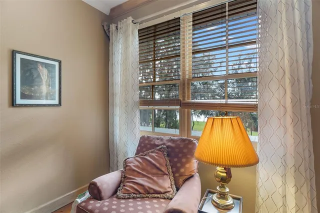a bedroom with a bed and large window