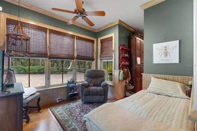 a bedroom with two beds and next to a window