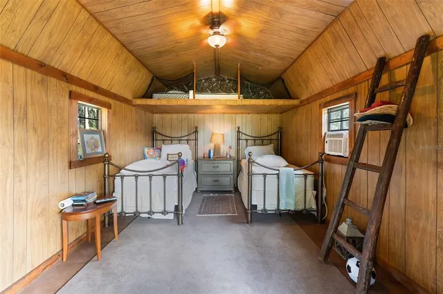 a view of house with swimming pool and sitting area
