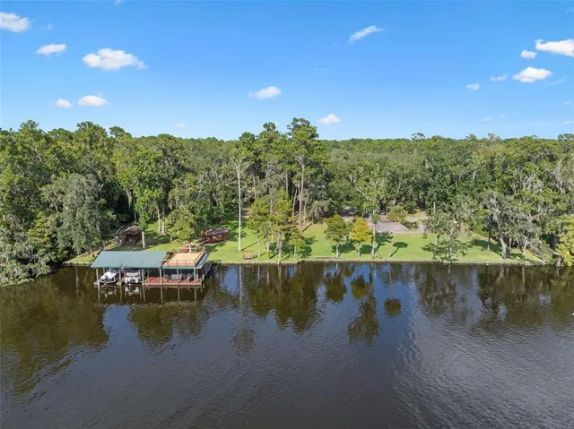 a living room with furniture ceiling fan and a window