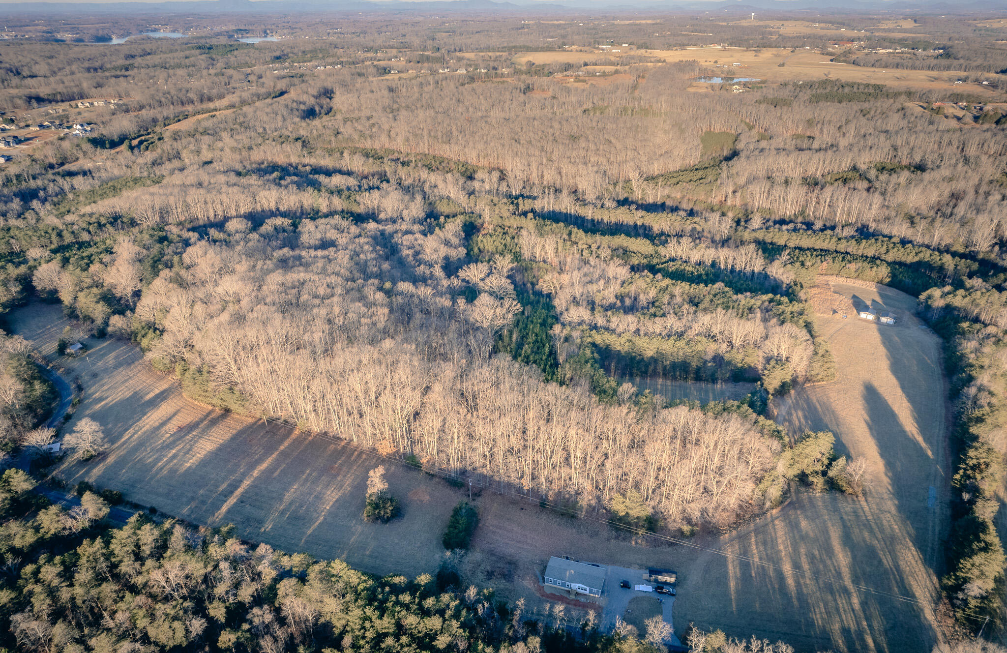 an aerial view of house with yard and ocean view