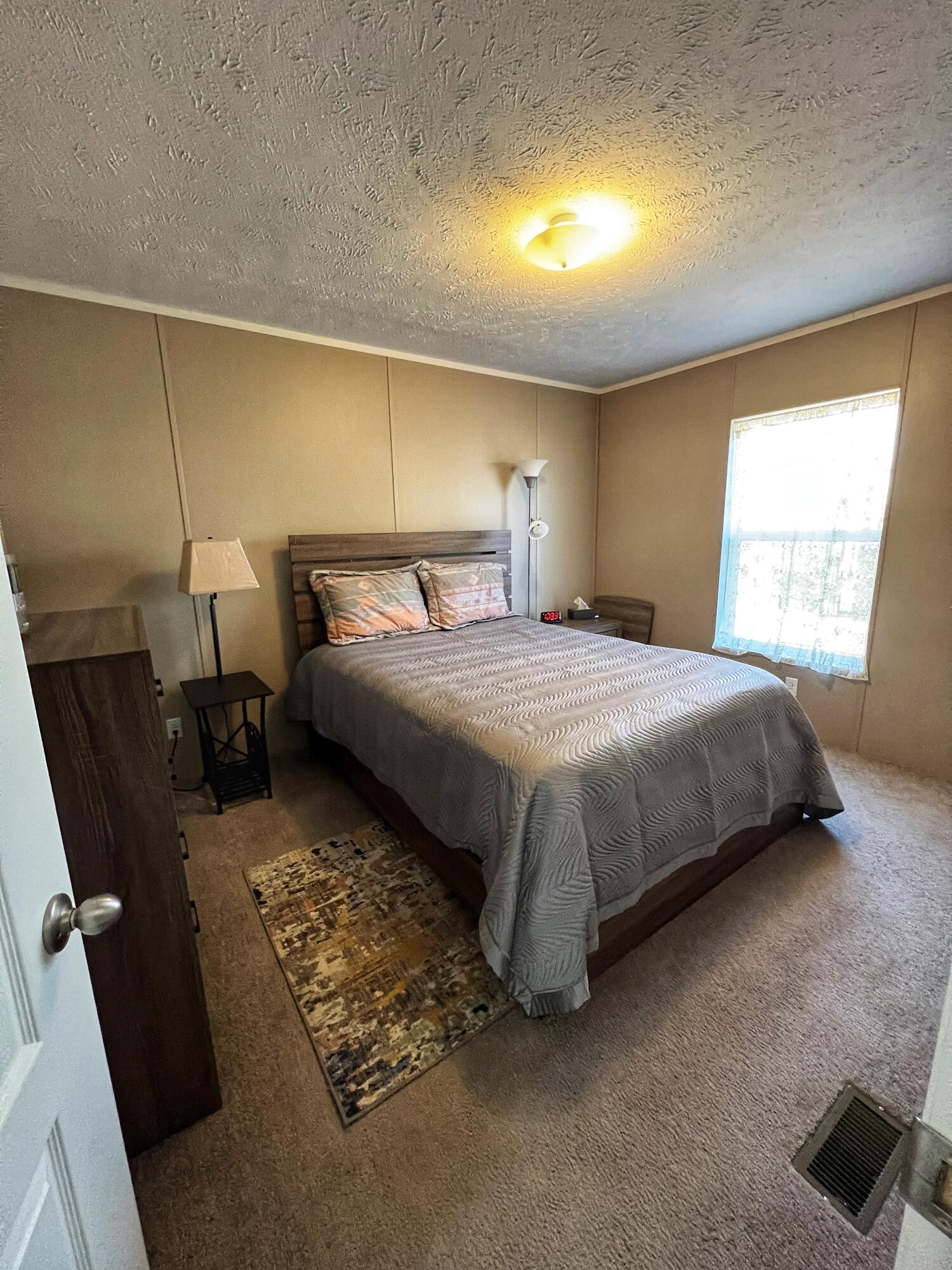 1485 Pine Ridge Road Huddleston, VA 24104 - Photo 14 of 52 a bed sitting in a bedroom next to a window