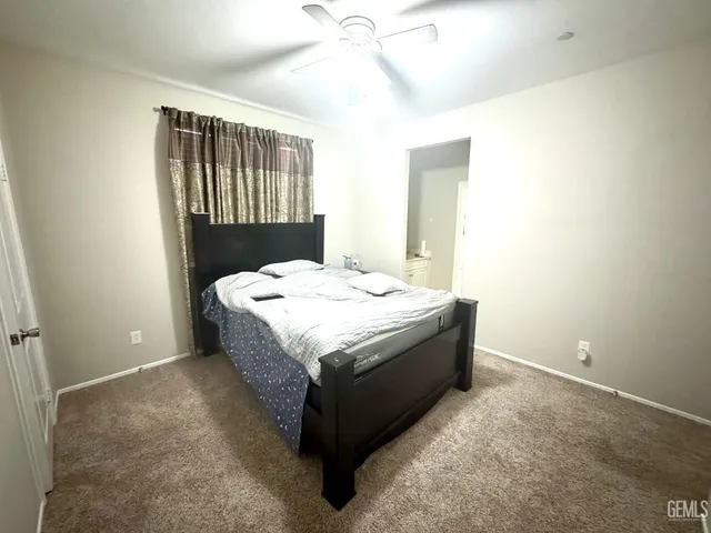 a spacious bedroom with a bed and a window