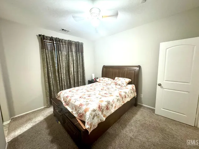 a bed sitting in a bedroom next to a bathroom