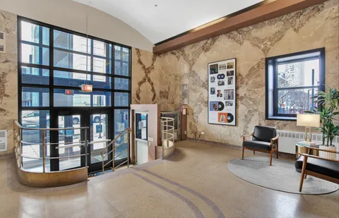 a view of a street with chairs