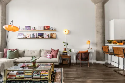 a living room with furniture and wooden floor