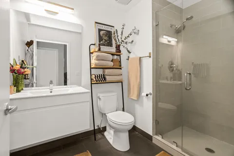 a bathroom with a toilet sink and shower