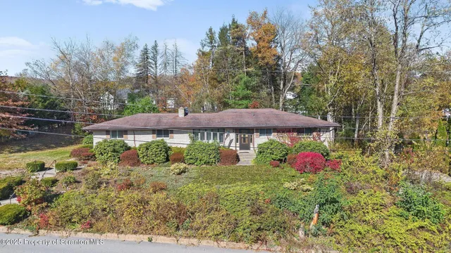 a view of a house with a yard and sitting area