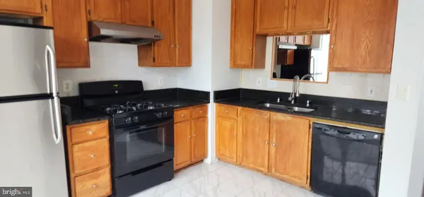 a kitchen with stainless steel appliances granite countertop a sink and a cabinets