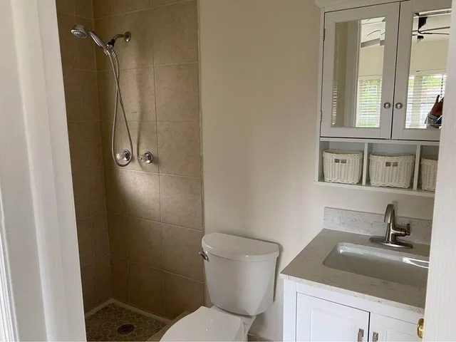 a bathroom with a sink toilet and shower