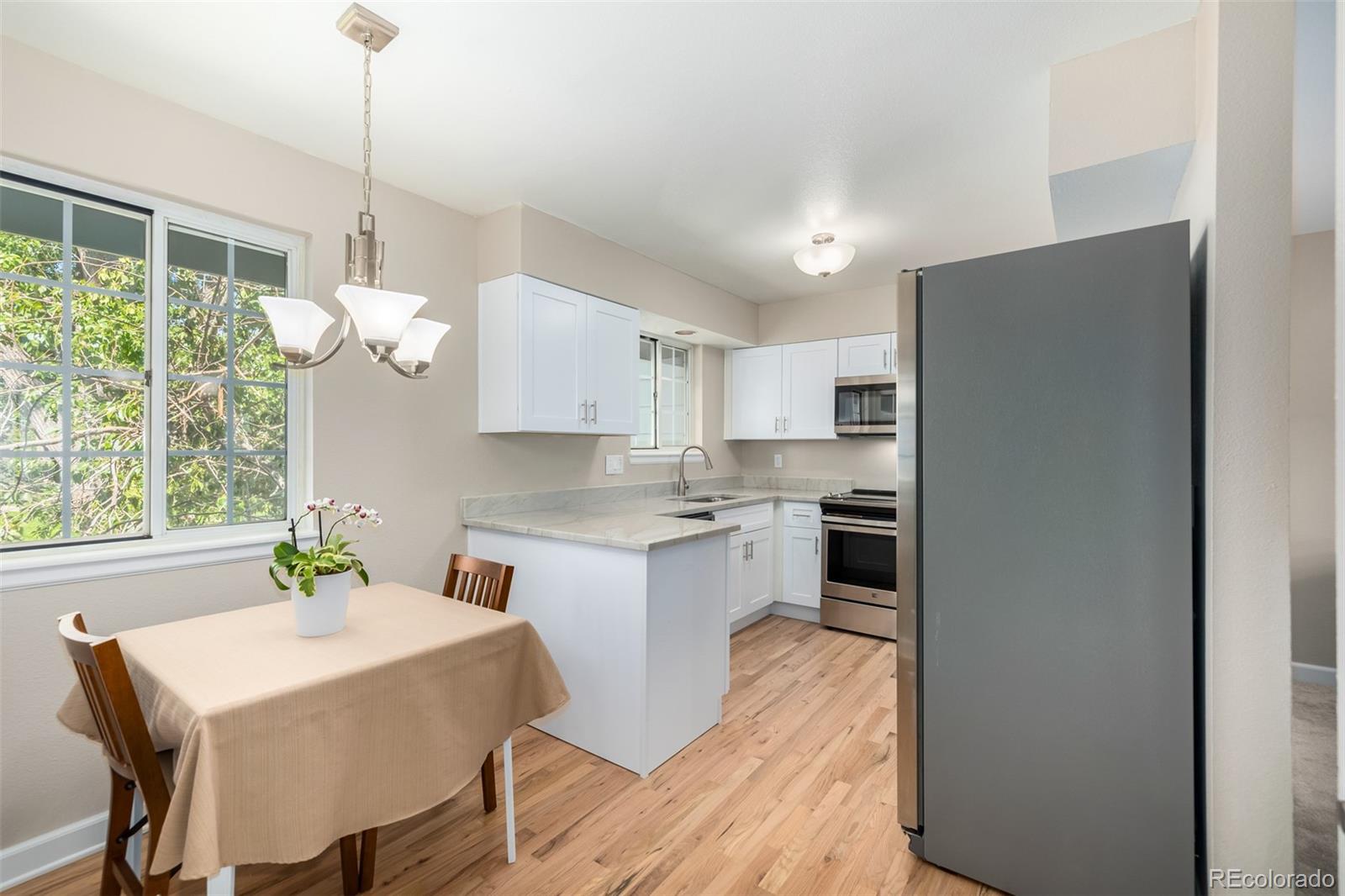 10401 West Red Mountain Road Littleton, CO 80127 - Photo 12 of 40 a kitchen with a table and chairs in it