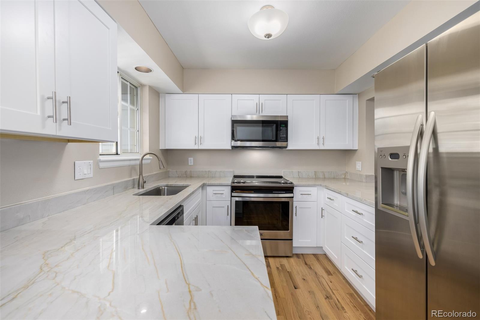 10401 West Red Mountain Road Littleton, CO 80127 - Photo 13 of 40 a kitchen with stainless steel appliances granite countertop a refrigerator sink and stove
