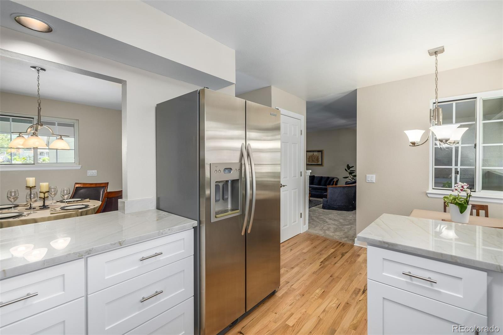 10401 West Red Mountain Road Littleton, CO 80127 - Photo 14 of 40 a kitchen with counter top space cabinets and stainless steel appliances