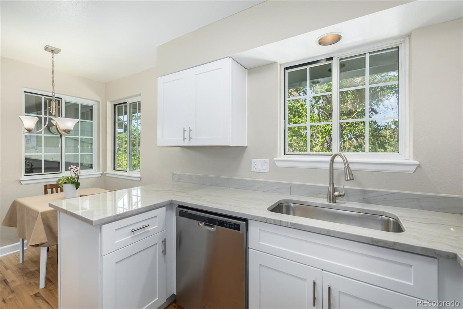 10401 West Red Mountain Road Littleton, CO 80127 - Photo 17 of 40 a kitchen with a sink cabinets and window