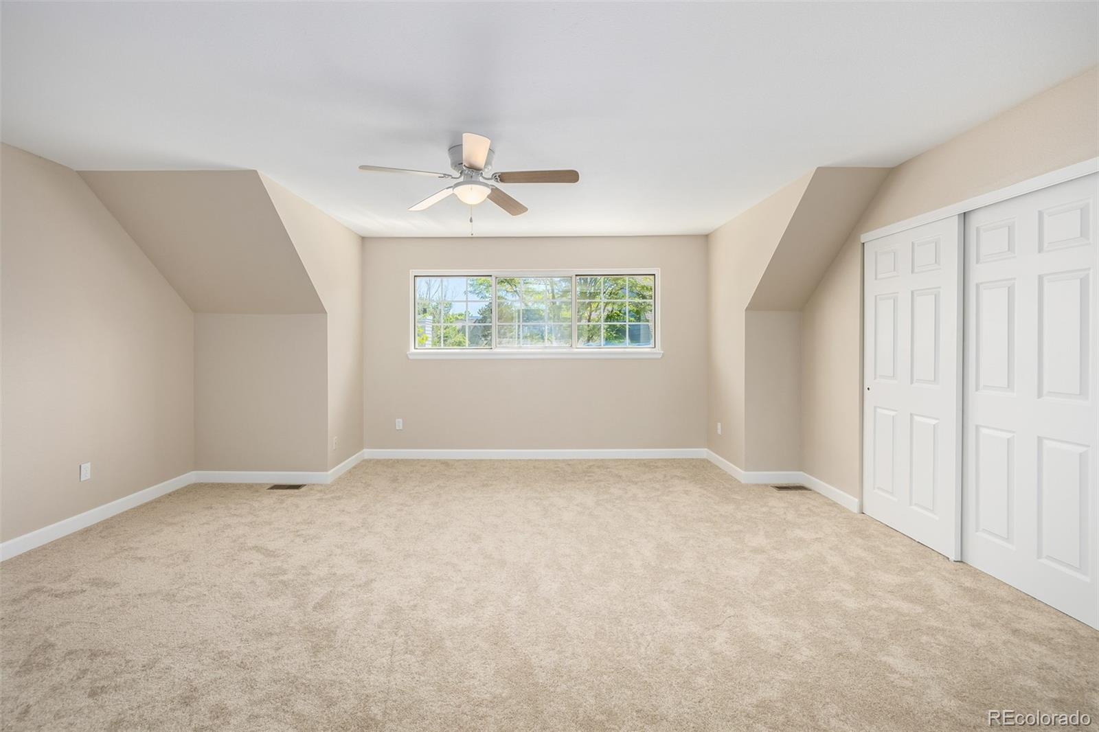 10401 West Red Mountain Road Littleton, CO 80127 - Photo 19 of 40 a view of an empty room with a window