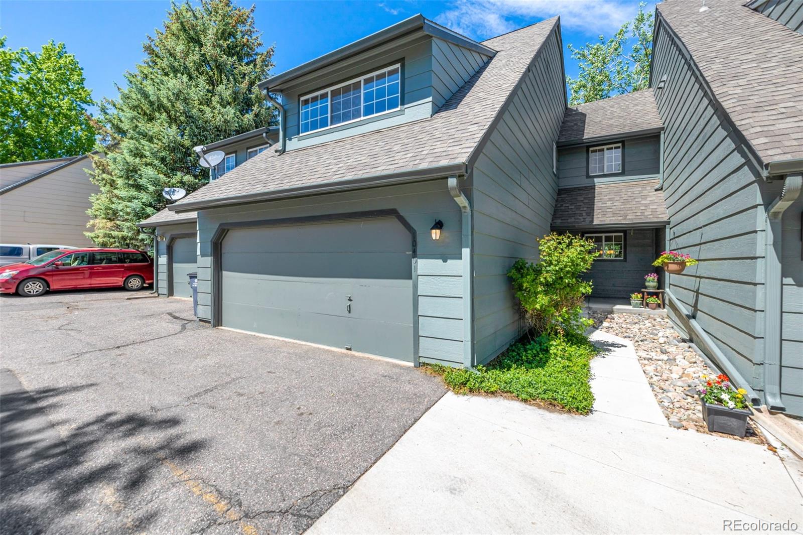 10401 West Red Mountain Road Littleton, CO 80127 - Photo 2 of 40 a front view of a house with a yard and garage