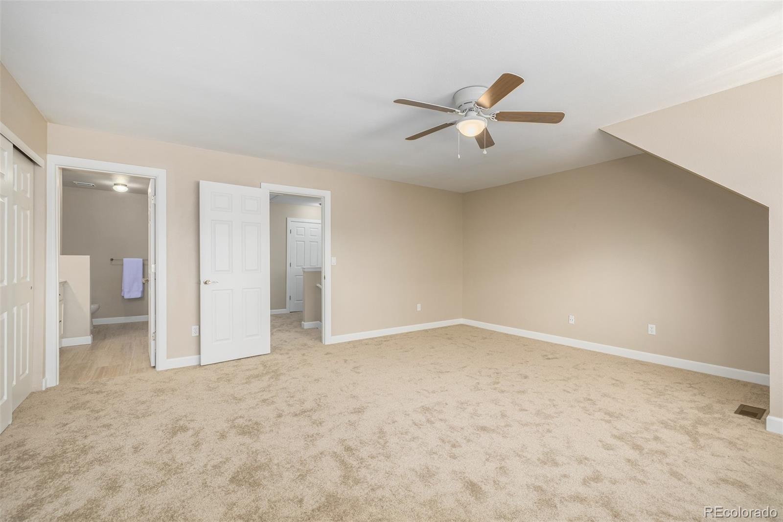 10401 West Red Mountain Road Littleton, CO 80127 - Photo 22 of 40 an empty room with fan and entrance