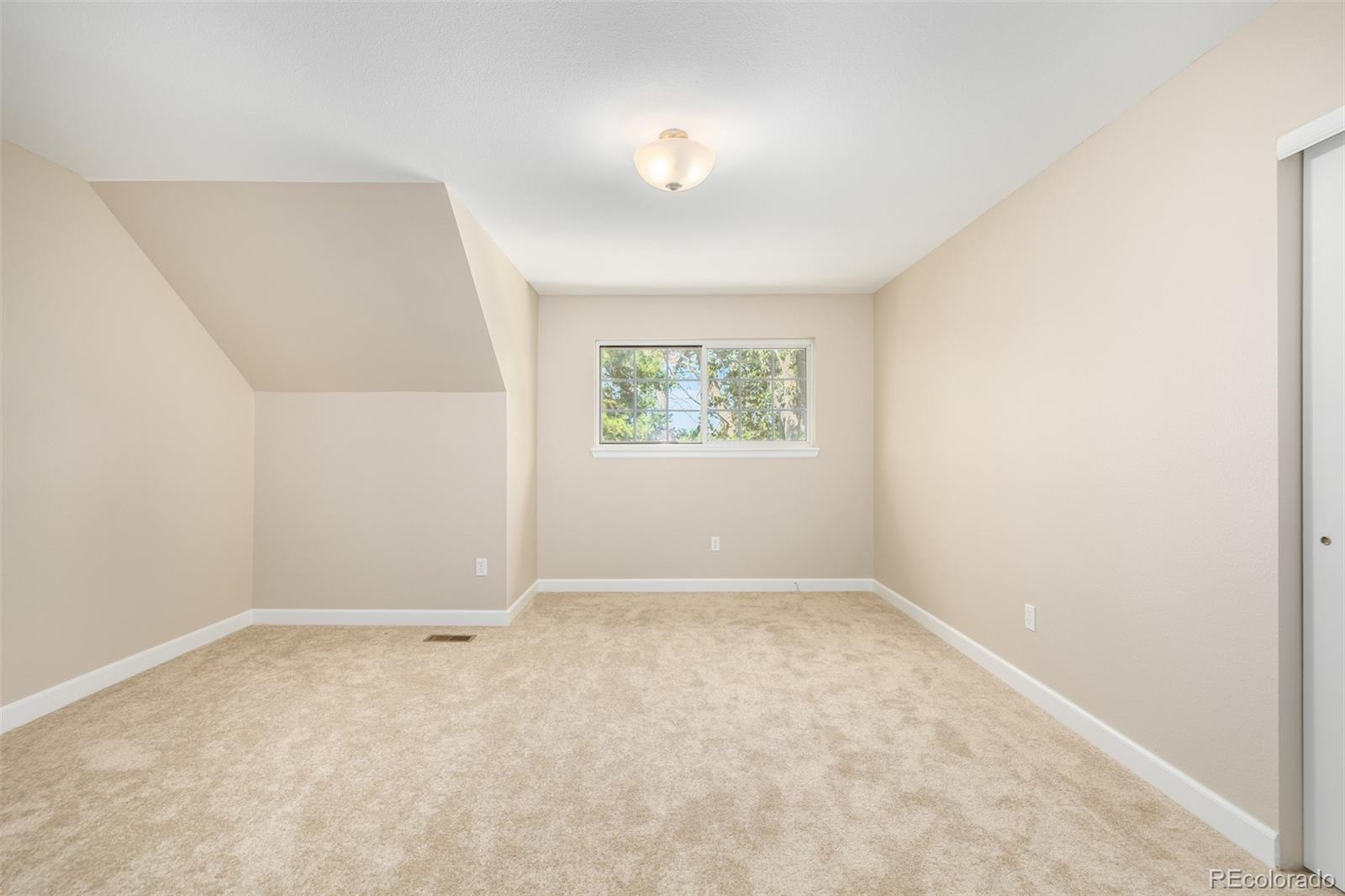 10401 West Red Mountain Road Littleton, CO 80127 - Photo 23 of 40 an empty room with a window