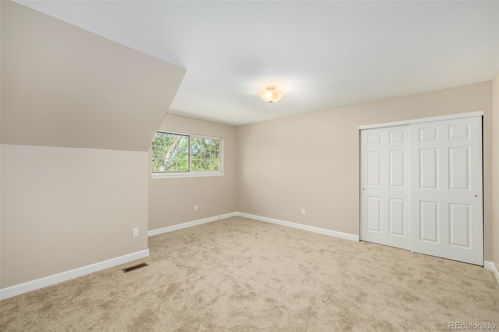 10401 West Red Mountain Road Littleton, CO 80127 - Photo 24 of 40 an empty room with windows