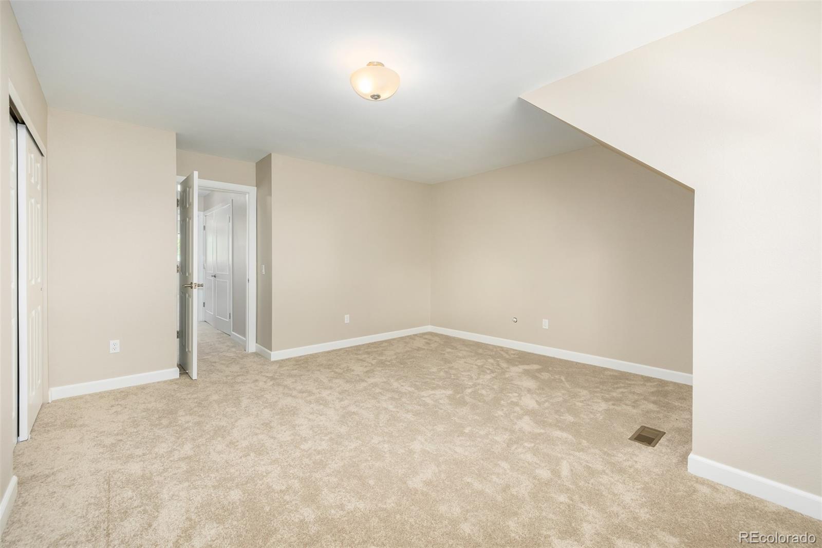 10401 West Red Mountain Road Littleton, CO 80127 - Photo 25 of 40 an empty room with an entryway