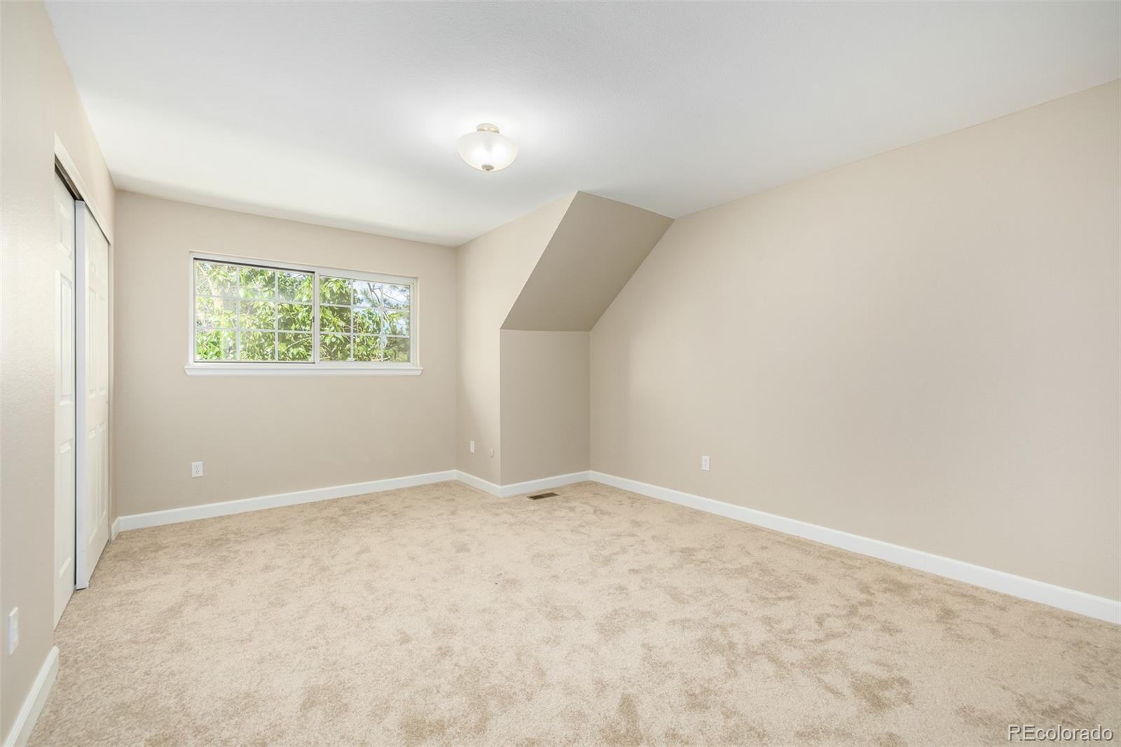 10401 West Red Mountain Road Littleton, CO 80127 - Photo 26 of 40 an empty room with windows