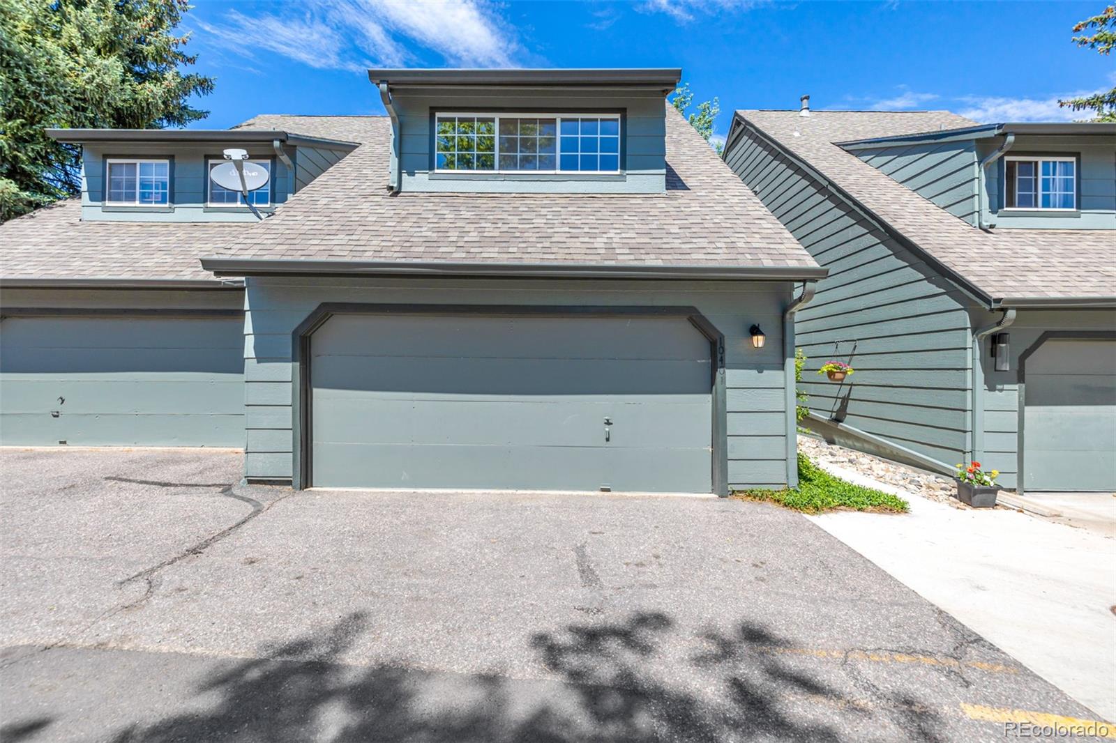 10401 West Red Mountain Road Littleton, CO 80127 - Photo 3 of 40 a front view of a house with a yard and garage