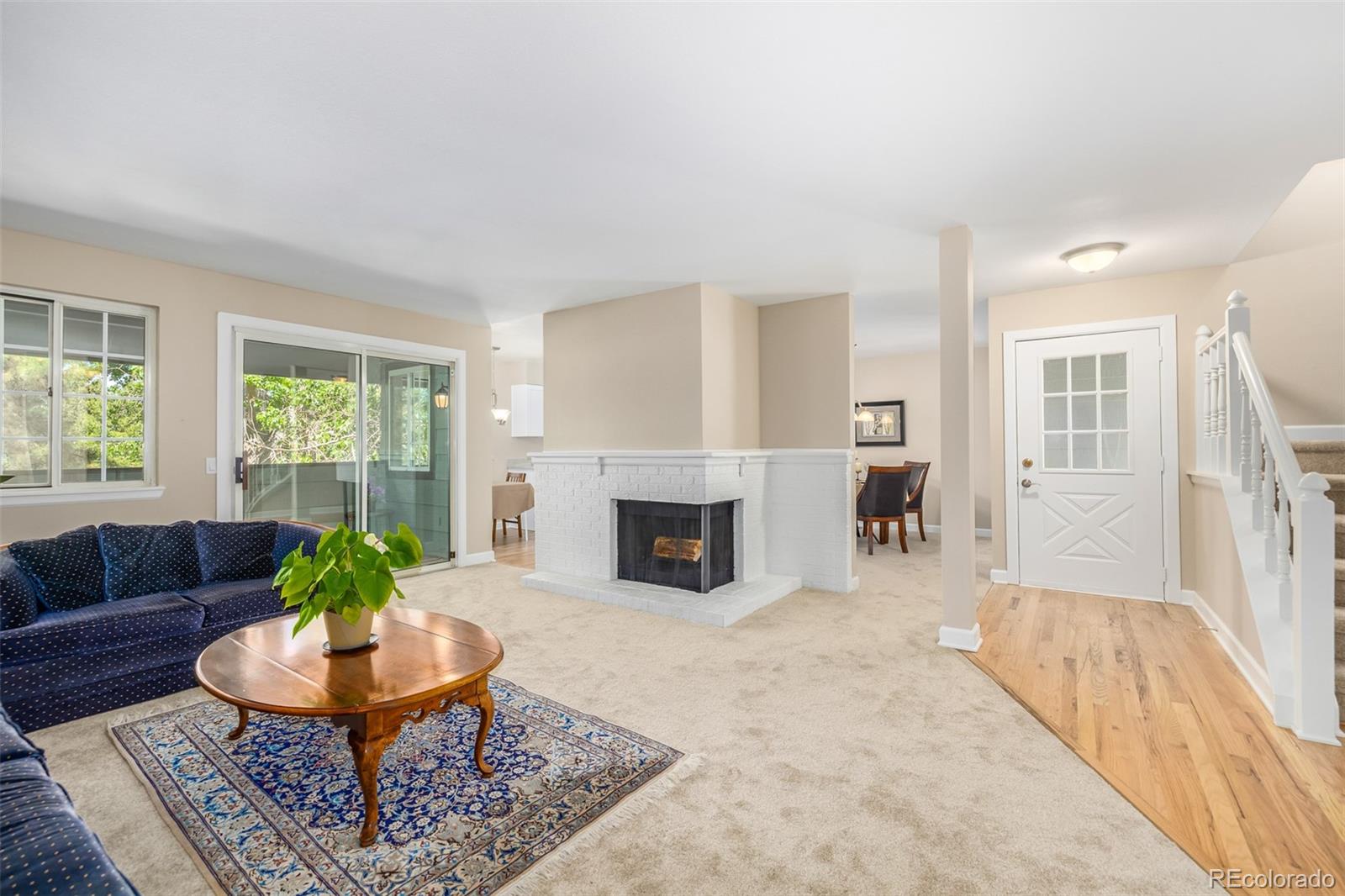 10401 West Red Mountain Road Littleton, CO 80127 - Photo 5 of 40 a living room with furniture a window and a fireplace