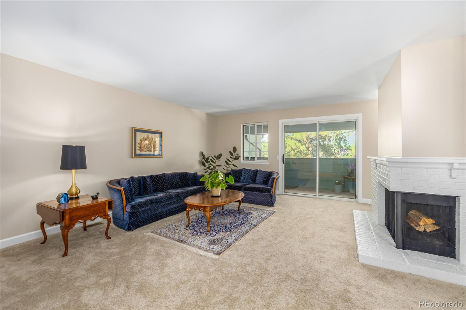 10401 West Red Mountain Road Littleton, CO 80127 - Photo 7 of 40 a living room with furniture and a fireplace