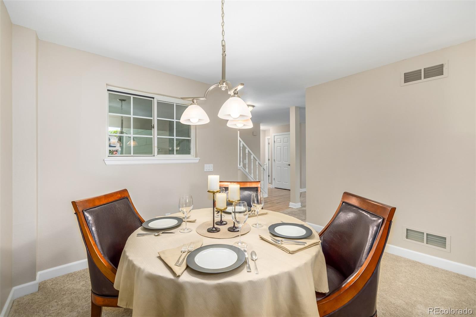 10401 West Red Mountain Road Littleton, CO 80127 - Photo 10 of 40 a view of a dining room with furniture window and outside view