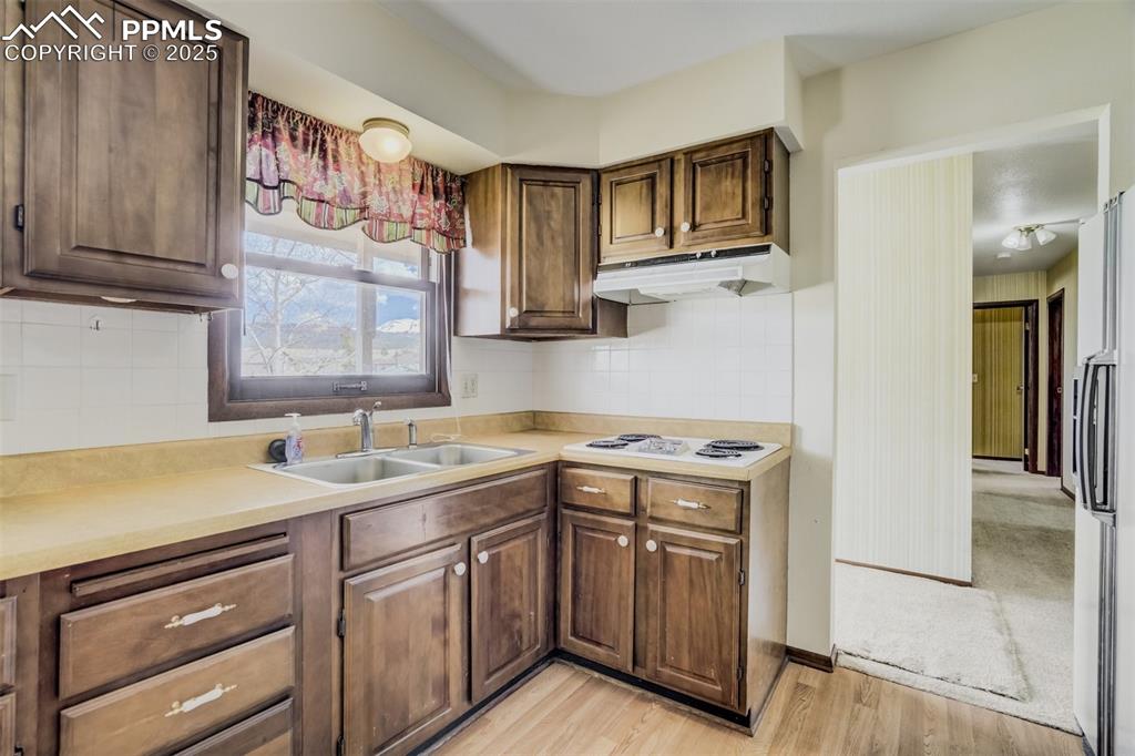 65 Yeoman Lane Divide, CO 80814 - Photo 9 of 43 a kitchen with a sink stove and cabinets