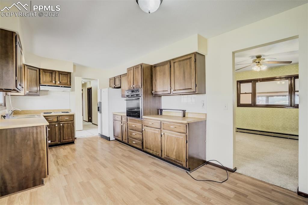 65 Yeoman Lane Divide, CO 80814 - Photo 10 of 43 a kitchen with stainless steel appliances granite countertop a stove a sink and a refrigerator