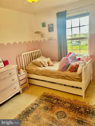 a bedroom with furniture and a large window