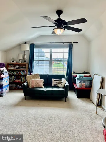 a view of a workspace with furniture and a book shelf
