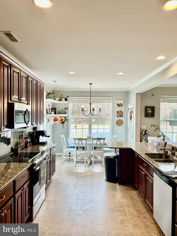 a view of a dining room with furniture large window and chandelier