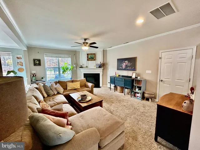 a living room with furniture fireplace and a window